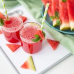 A glass of freshly squeezed fresh watermelon juice, a healthy watermelon and mint leaf smoothie.