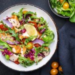 Gourmet salad with grilled salmon with tomatoes, cucumber, arugula, radicchio, red onion and lettuce