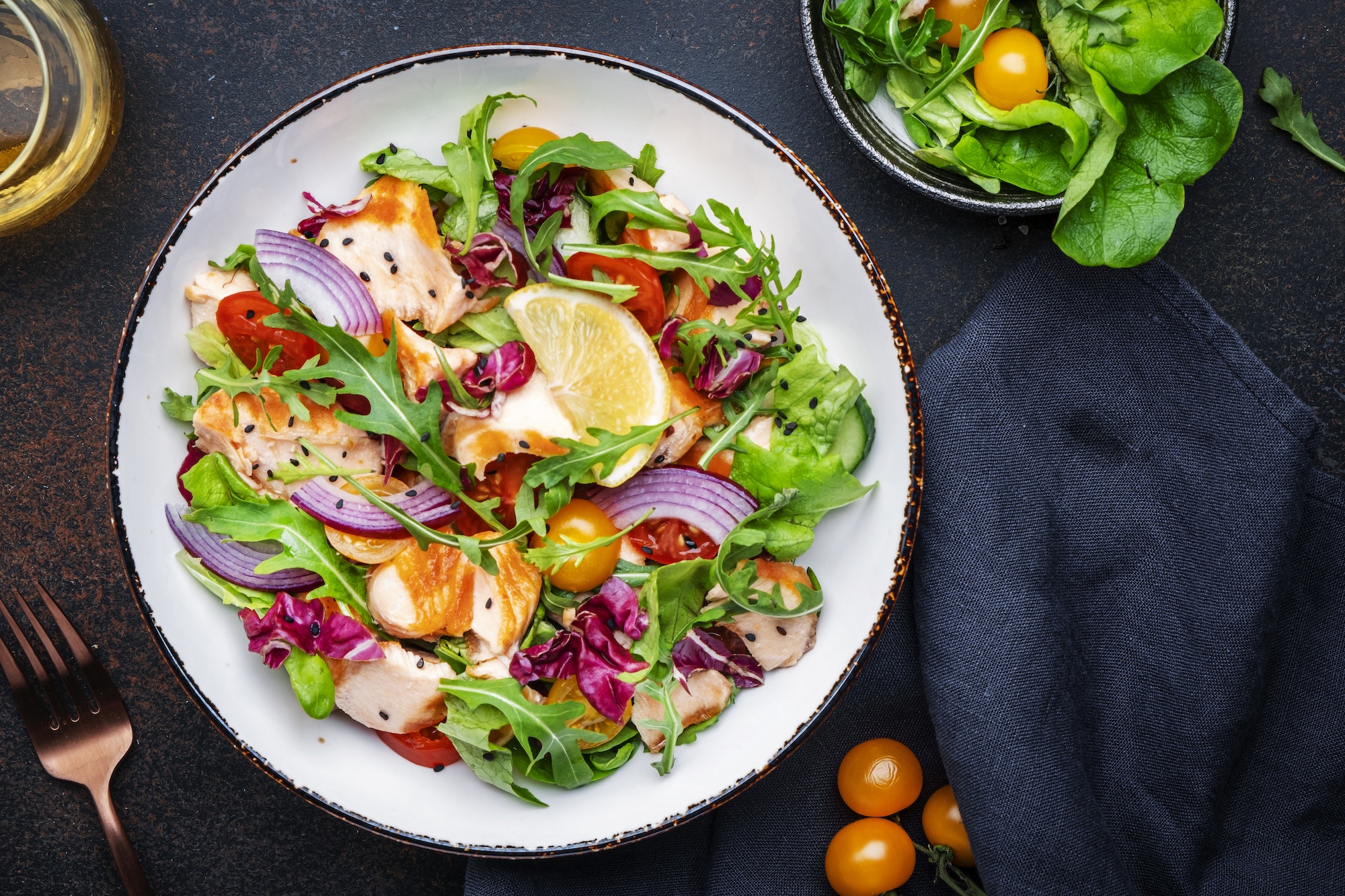 Gourmet salad with grilled salmon with tomatoes, cucumber, arugula, radicchio, red onion and lettuce