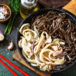 Spicy Noodles, Korean traditional food. Buckwheat soba noodles and squid with sour cream sauce.