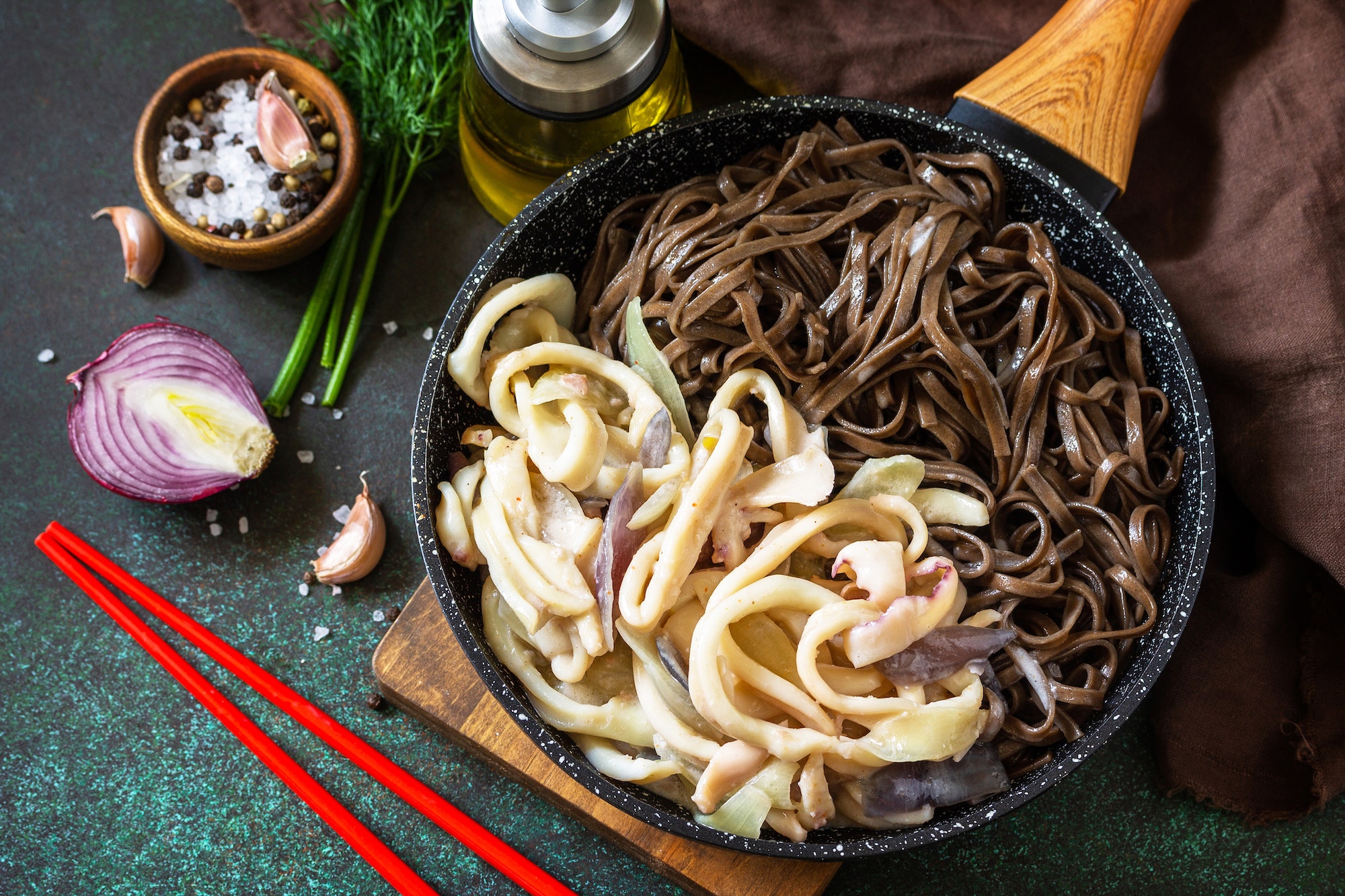 Spicy Noodles, Korean traditional food. Buckwheat soba noodles and squid with sour cream sauce.