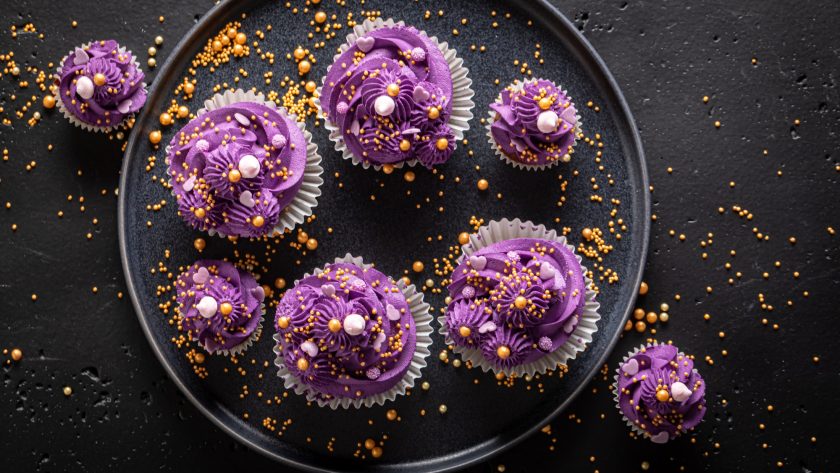 Sweet cupcakes with violet cream ready to eat.